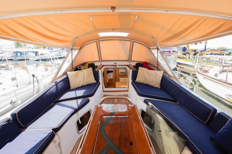 Slide: The Image of 2010 Jeanneau Sun Odyssey 50 DS yacht interior with blue seating and orange canopy. - 65