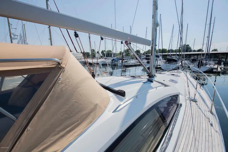 Slide: The Image of 2010 Jeanneau Sun Odyssey 50 DS sailboat docked in marina, showcasing sleek design and deck features. - 71