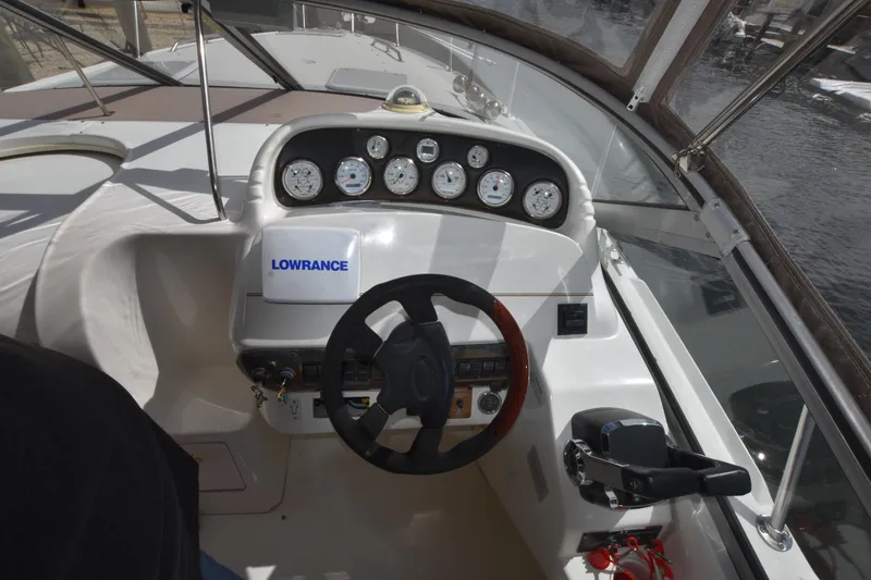 Slide: The Image of 2001 Larson Cabrio 330 boat dashboard with steering wheel and gauges. - 15