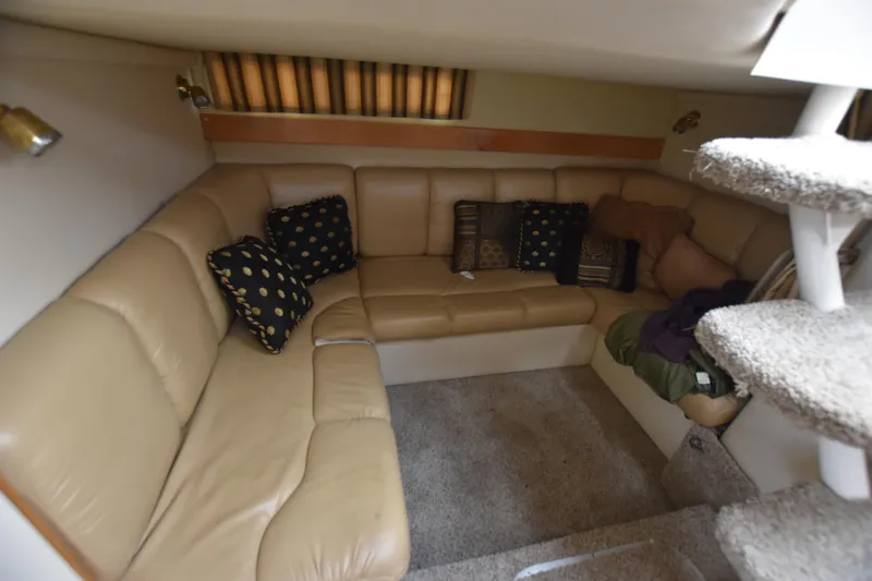 Slide: The Image of 2001 Larson Cabrio 330 interior with beige leather seating and decorative pillows. - 24