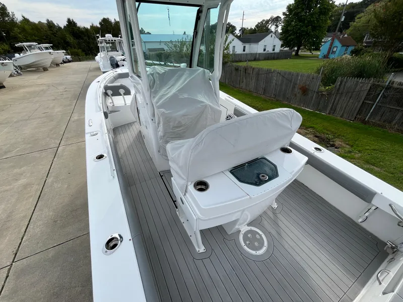 Slide: The Image of 2023 Everglades 253 Center Console boat, sleek design, spacious deck, outdoor setting. - 10
