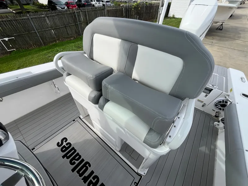 Slide: The Image of 2023 Everglades 253 Center Console boat seating with gray and white upholstery. - 14