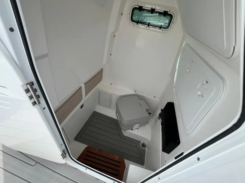Slide: The Image of 2023 Everglades 253 Center Console boat interior with compact marine toilet. - 22