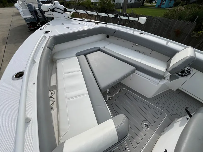 Slide: The Image of 2023 Everglades 253 Center Console boat interior with cushioned seating and modern design. - 25
