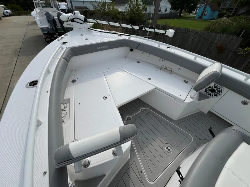Slide: The Image of 2023 Everglades 253 Center Console boat interior with seating and storage. - 26