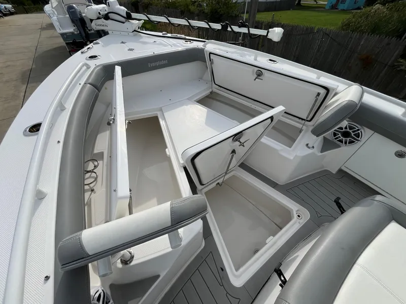 Slide: The Image of 2023 Everglades 253 Center Console boat with open storage compartments and sleek design. - 27