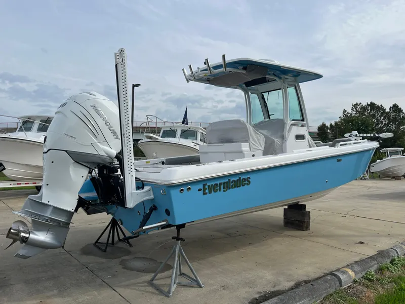Slide: The Image of 2023 Everglades 253 Center Console boat, blue hull, on display outdoors. - 3