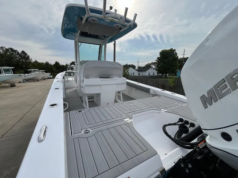 Slide: The Image of 2023 Everglades 253 Center Console boat with Mercury engine, docked outdoors. - 6