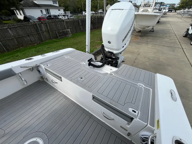 Slide: The Image of 2023 Everglades 253 Center Console boat with sleek deck and powerful outboard motor. - 7
