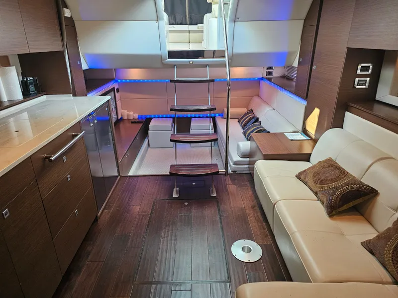 Slide: The Image of Luxurious interior of 2012 Sea Ray SUNDANCE yacht with modern furnishings and ambient lighting. - 13