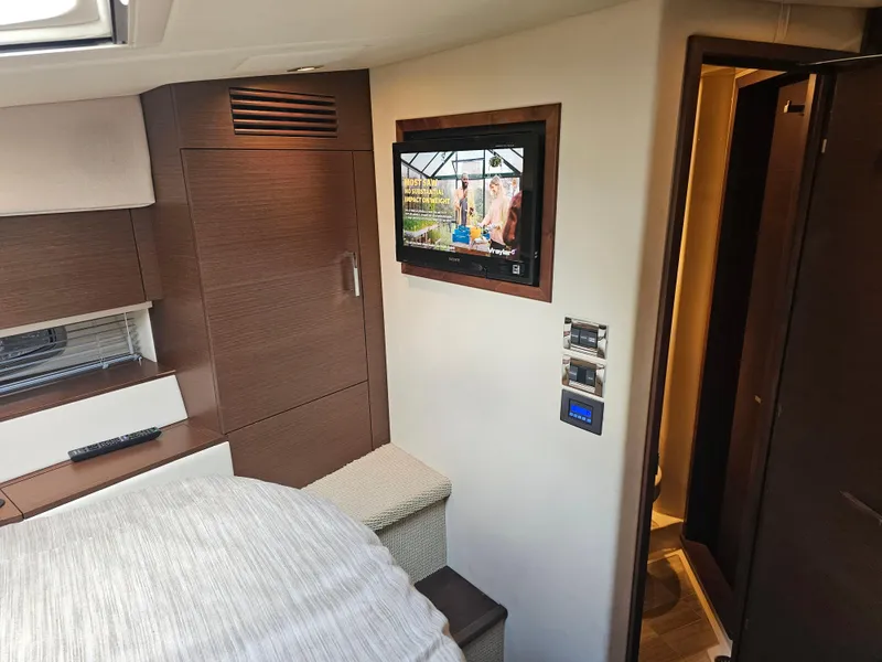 Slide: The Image of Interior of 2012 Sea Ray SUNDANCE yacht with TV and modern wood paneling. - 15
