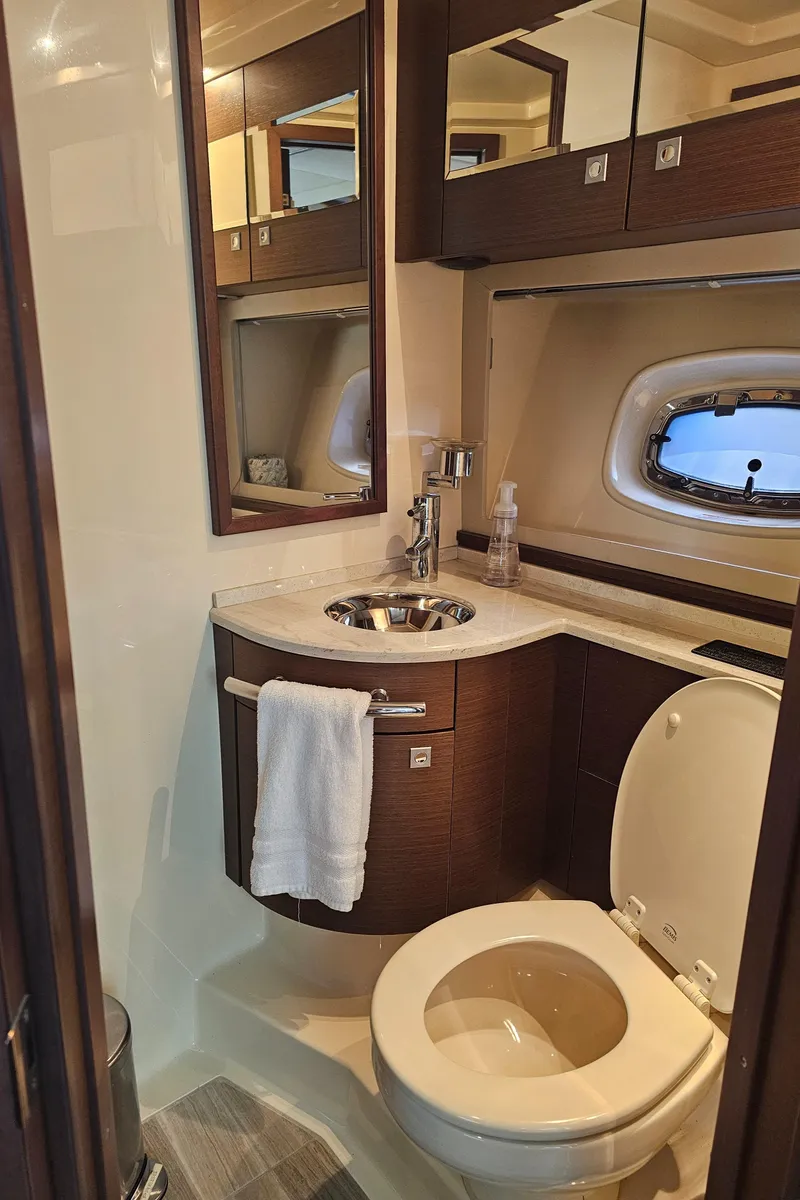 Slide: The Image of Luxurious bathroom in 2012 Sea Ray SUNDANCE yacht with modern fixtures and porthole window. - 16