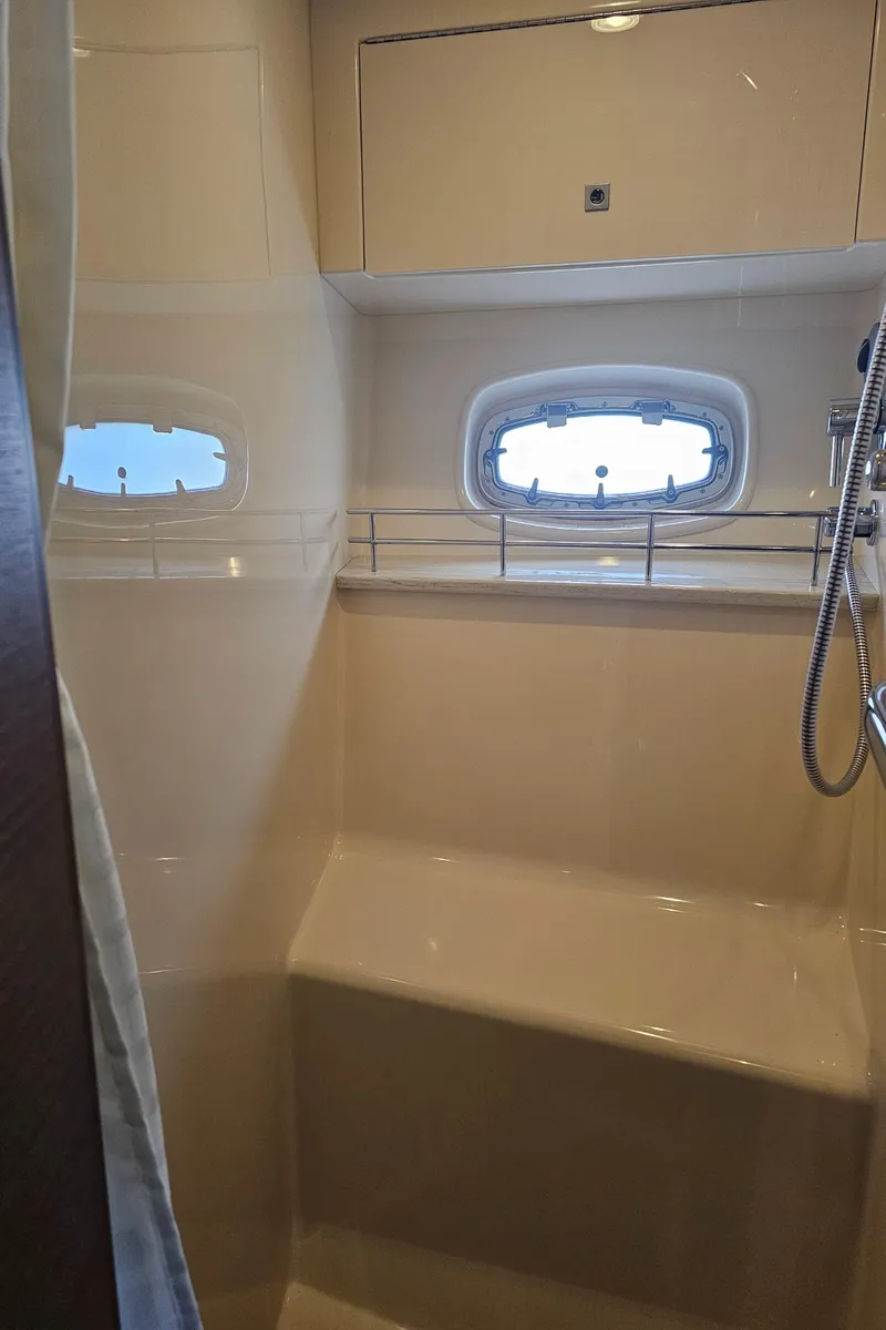 Slide: The Image of 2012 Sea Ray SUNDANCE yacht bathroom with window and shower. - 17