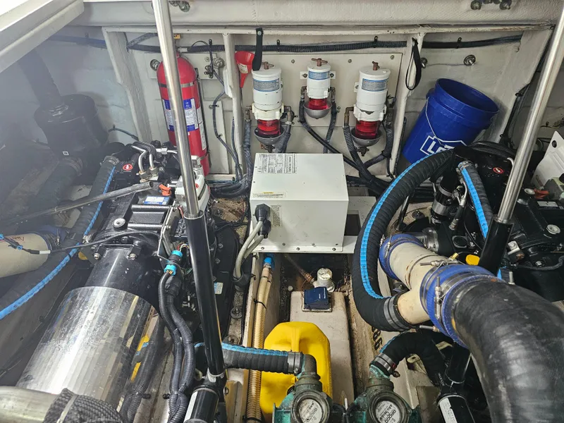 Slide: The Image of Engine room of a 2012 Sea Ray SUNDANCE boat, showcasing mechanical components and equipment. - 18