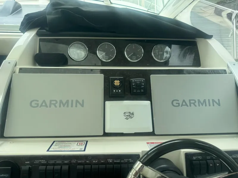 Slide: The Image of Control panel of 2012 Sea Ray SUNDANCE boat with Garmin navigation displays. - 2