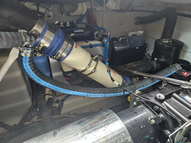 Slide: The Image of Engine compartment of a 2012 Sea Ray SUNDANCE boat, showing hoses and mechanical components. - 20