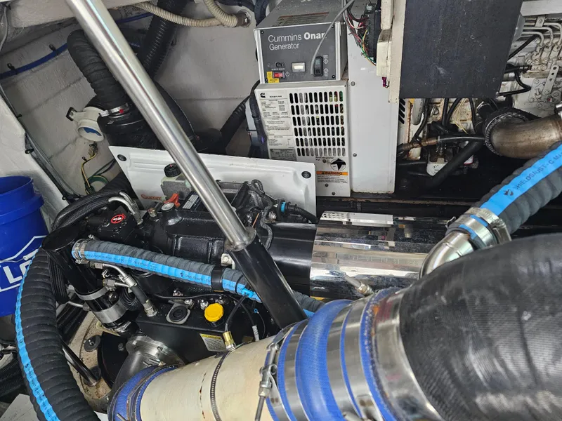 Slide: The Image of Engine room of 2012 Sea Ray SUNDANCE with Cummins Onan generator and blue hoses. - 21