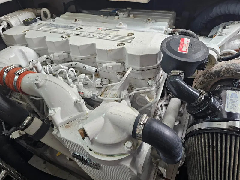Slide: The Image of Engine of a 2012 Sea Ray SUNDANCE boat, showcasing intricate mechanical components. - 22