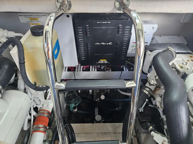 Slide: The Image of Engine compartment of 2012 Sea Ray SUNDANCE boat, showing mechanical components and ladder. - 23