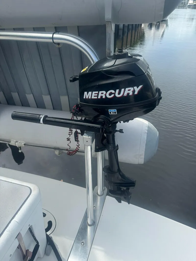 Slide: The Image of Mercury outboard motor on a 2012 Sea Ray SUNDANCE boat, docked by the water. - 27