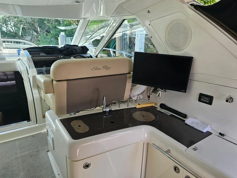 Slide: The Image of 2012 Sea Ray SUNDANCE yacht interior with helm, seating, and entertainment system. - 5
