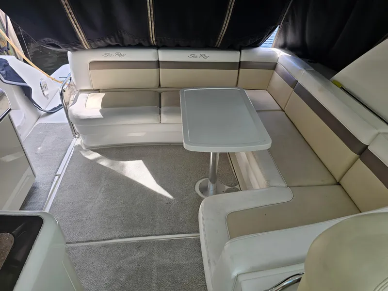 Slide: The Image of 2012 Sea Ray SUNDANCE interior with beige seating and a central table. - 6