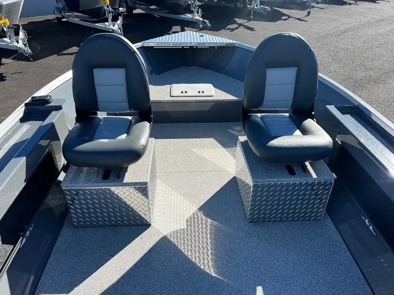 Slide: The Image of 2025 Fish Rite Angler 18 boat interior with two cushioned seats on metal bases. - 11