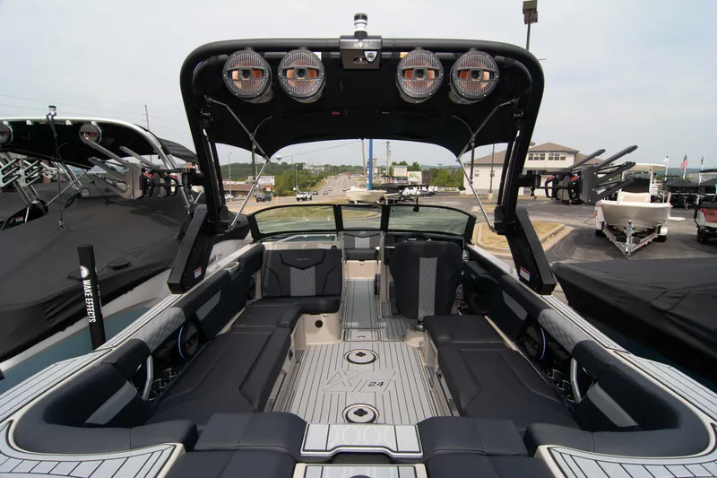 Slide: The Image of 2025 MasterCraft XT24 boat interior with sleek seating and advanced audio system. - 14