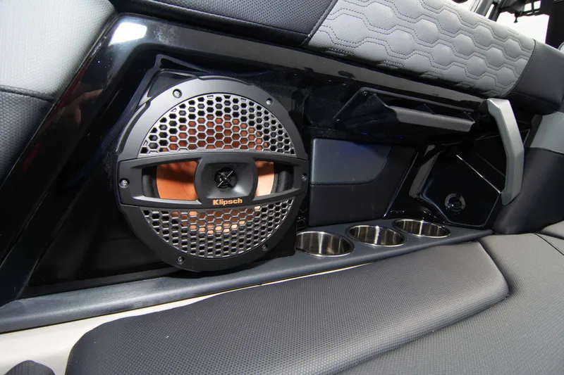 Slide: The Image of 2025 MasterCraft XT24 interior with Klipsch speaker and cup holders. - 26