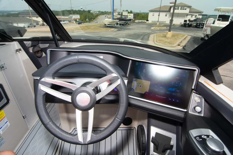 Slide: The Image of 2025 MasterCraft XT24 boat dashboard with modern steering wheel and touchscreen display. - 31