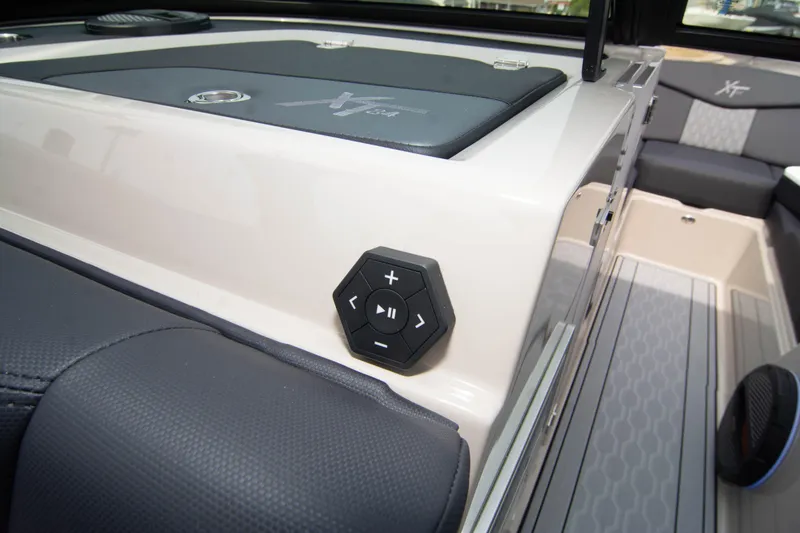 Slide: The Image of 2025 MasterCraft XT24 boat interior with audio controls and seating. - 43