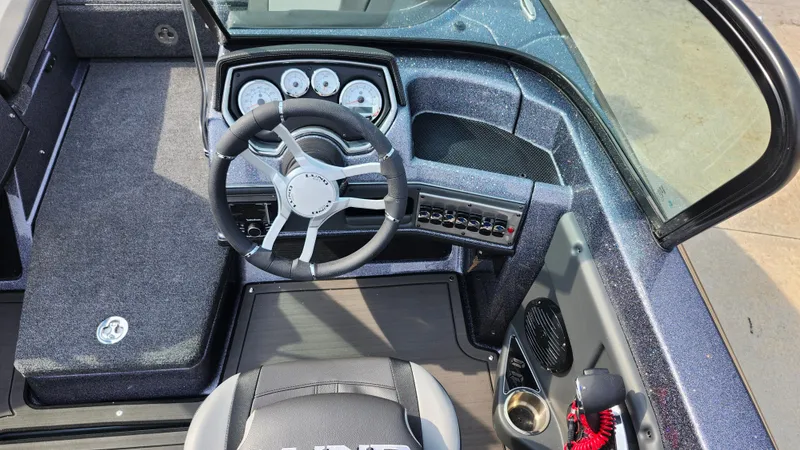 Slide: The Image of 2025 Lund 189 Tyee GL boat interior with steering wheel and dashboard controls. - 10