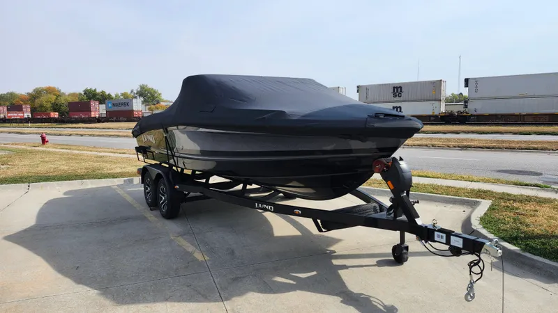 Slide: The Image of 2025 Lund 189 Tyee GL boat on trailer, covered, parked outdoors. - 12