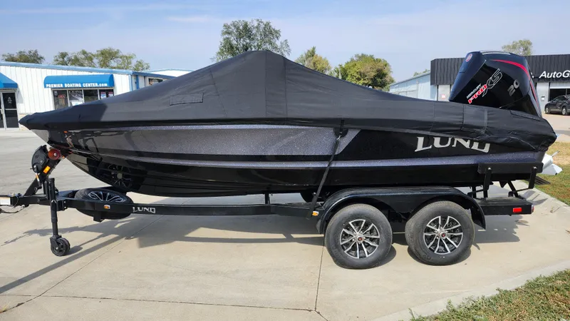 Slide: The Image of 2025 Lund 189 Tyee GL boat on trailer, covered, parked outdoors. - 17