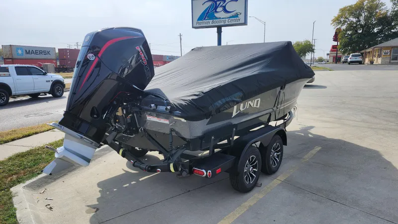 Slide: The Image of 2025 Lund 189 Tyee GL boat on trailer, covered, parked outdoors. - 18