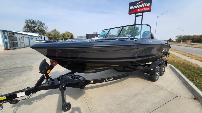 Slide: The Image of 2025 Lund 189 Tyee GL boat on trailer in parking lot. - 2