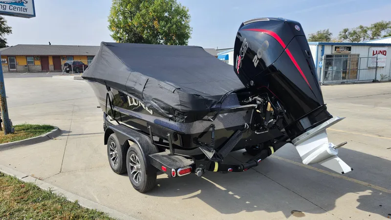 Slide: The Image of 2025 Lund 189 Tyee GL boat on trailer, covered and parked outdoors. - 20