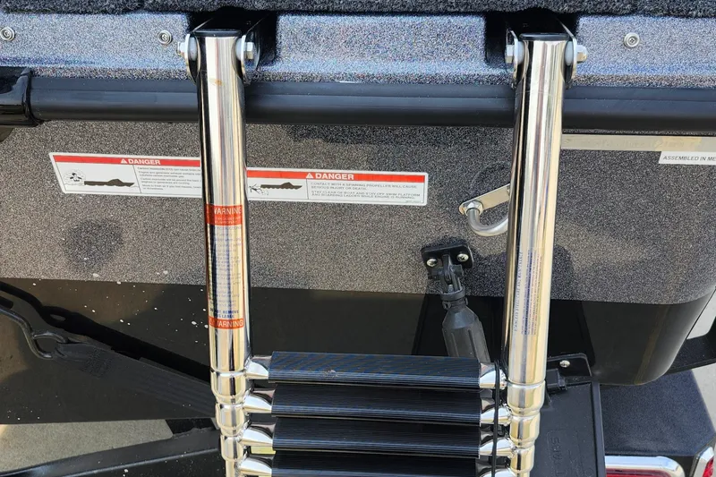 Slide: The Image of 2025 Lund 189 Tyee GL boat ladder with safety warnings. - 24