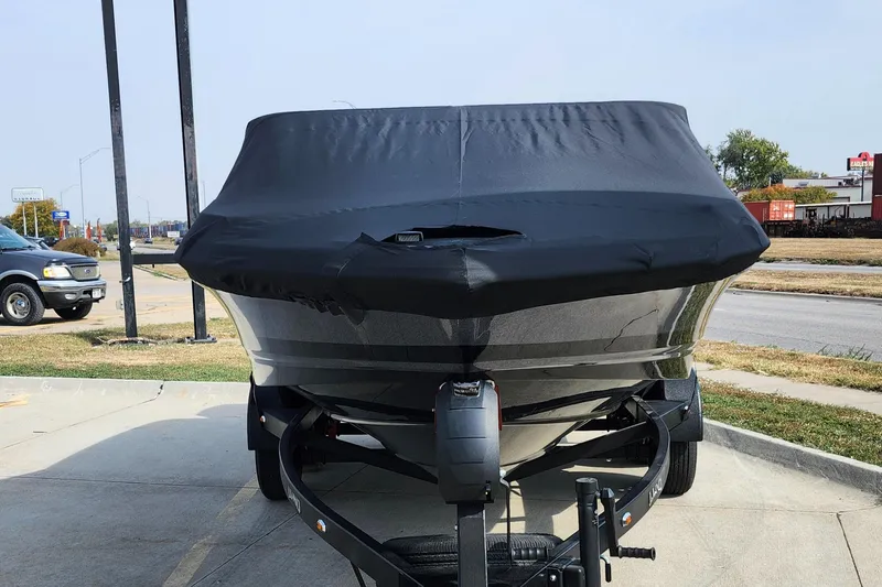 Slide: The Image of 2025 Lund 189 Tyee GL boat with cover on trailer, parked outdoors. - 27