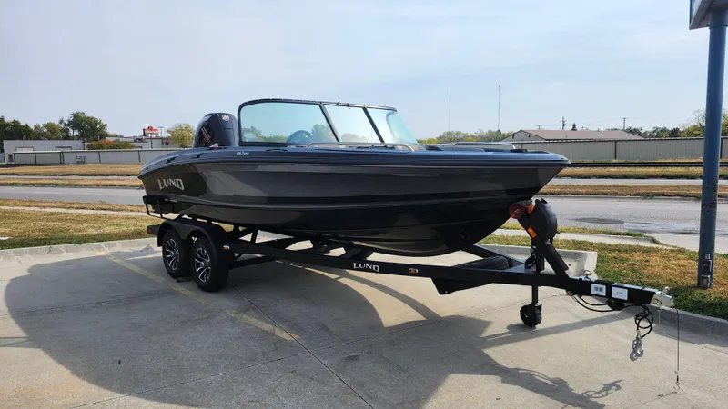 Slide: The Image of 2025 Lund 189 Tyee GL boat on trailer, parked outdoors. - 3