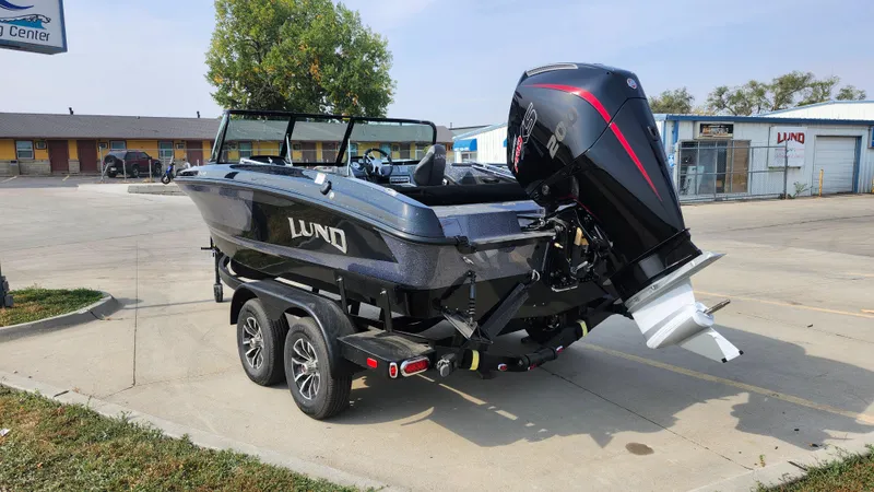Slide: The Image of 2025 Lund 189 Tyee GL boat on trailer, parked outdoors. - 4