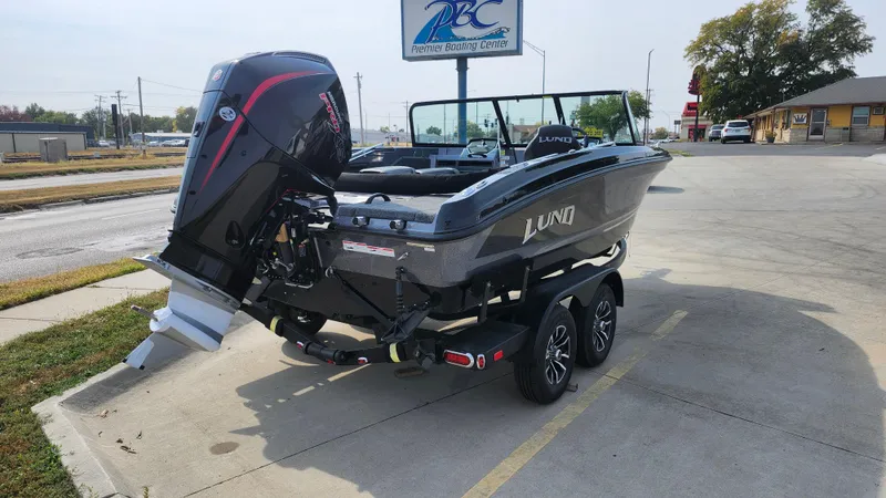 Slide: The Image of 2025 Lund 189 Tyee GL boat on trailer, parked outdoors. - 7