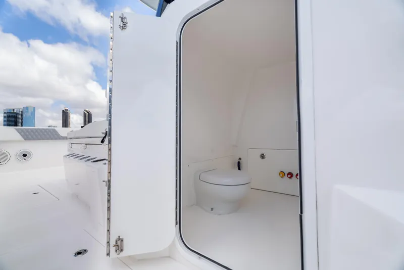 Slide: The Image of 2020 Invincible 35 Catamaran interior with open door to compact bathroom. - 11