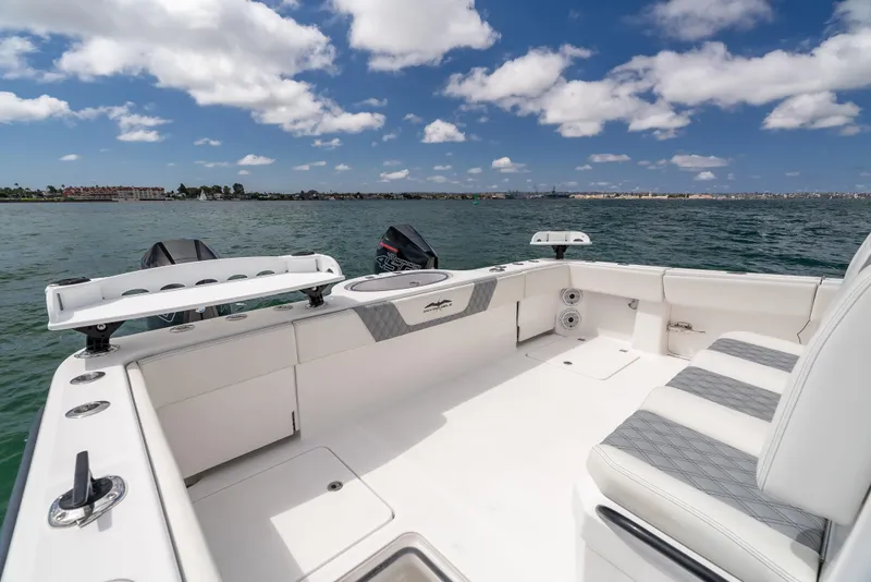 Slide: The Image of 2020 Invincible 35 Catamaran on water, spacious deck, clear sky, and scenic view. - 14