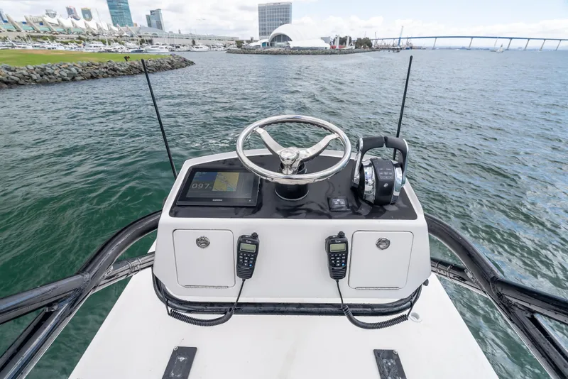 Slide: The Image of Invincible 35 Catamaran 2020 helm with steering wheel and controls, overlooking waterfront. - 16
