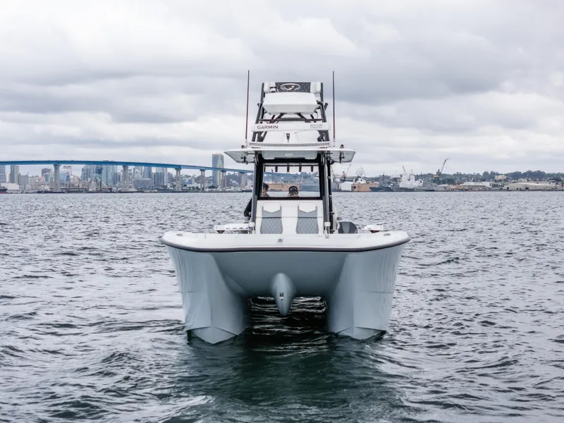 Slide: The Image of 2020 Invincible 35 Catamaran on water with city skyline in background. - 2