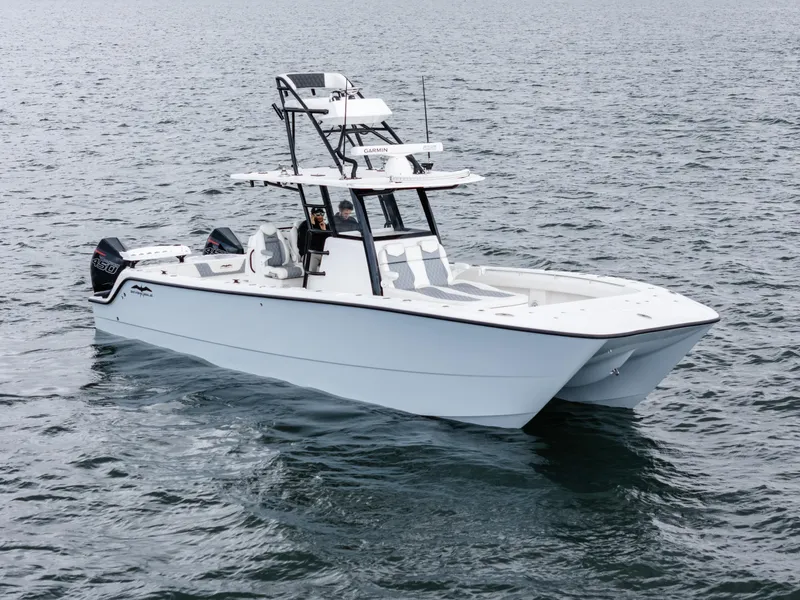 Slide: The Image of 2020 Invincible 35 Catamaran on open water, showcasing sleek design and powerful engines. - 3