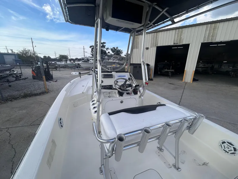 Slide: The Image of 2013 Skeeter SX2250 boat with center console, docked near a warehouse. - 11