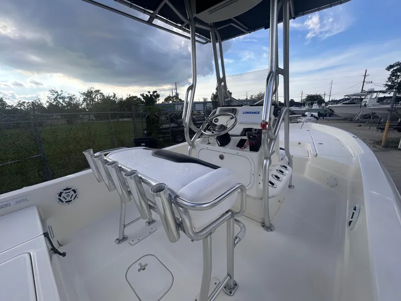Slide: The Image of 2013 Skeeter SX2250 boat interior with seating and steering console under a canopy. - 12