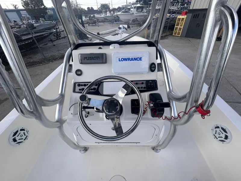 Slide: The Image of 2013 Skeeter SX2250 boat console with steering wheel, electronics, and controls. - 15